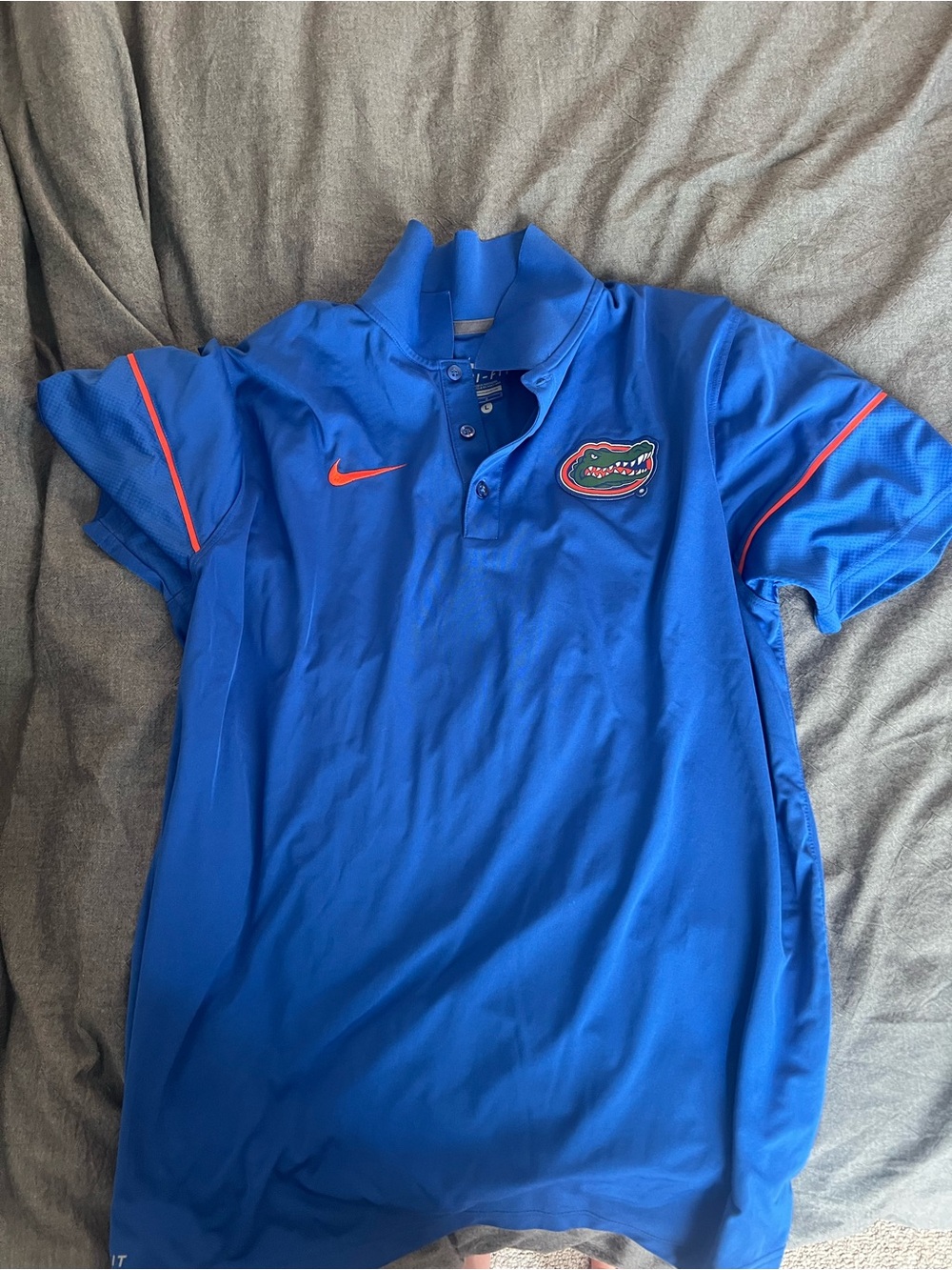 Nike men’s Royal Blue Polo with Orange Accents and Gators Patch